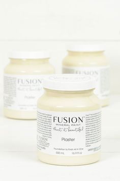 three jars of cream sitting on top of a white table next to each other with the words fusion written in it