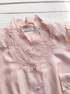 A silky pastel pink blouse, with very detailed cutwork lace and embroidery on the collar and neckline. ☛ m e a s u r e m e n t s ☚ Best for: M Bust: 40 Waist: 34 Shoulders: 15 Length: 25 ☛ d e t a i l s ☚ Era: 1980s Material: polyester Condition: excellent Pastel Pink Blouse, Cottagecore Blouse, Cutwork Lace, Cute Cottagecore, Silky Blouse, Rose Pastel, Rose Vintage, Pink Blouse, Cut Work