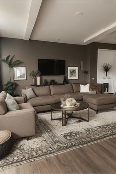 a living room filled with furniture and a flat screen tv mounted to the side of a wall