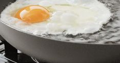 an egg is frying in a pan on the stove