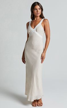 Get ready to turn heads in our Chakyra Midi Dress! This stunning slip dress boasts a deep V-neckline and sleeveless design, perfect for showing off your confidence and style. The neutral beige color is complemented with white contrast detailing, giving this dress a chic and modern edge. Made from high-quality polyester, it's both comfortable and durable, making it the ideal choice for any occasion. Whether you're heading to a casual day out or getting ready for a party night, this versatile midi Summer V-neck Slip Dress With Delicate Straps, White V-neck Dress With Delicate Straps, White V-neck Dresses With Delicate Straps, White Dresses With Delicate Straps And V-neck, Chic V-neck Slip Dress With Delicate Straps, Elegant Beige Dress With Delicate Straps, White V-neck Slip Dress With Delicate Straps, V-neck Slip Dress With Delicate Straps For Wedding, Elegant V-neck Dress With Built-in Bra