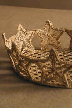 a decorative gold crown sitting on top of a table