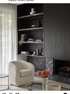 a living room filled with furniture and a fire place next to a wall mounted fireplace