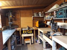 a workbench with many tools on it in a wood paneled workshop area