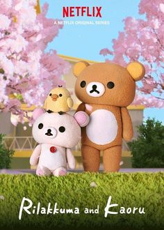 two teddy bears standing next to each other in front of pink flowers and a building