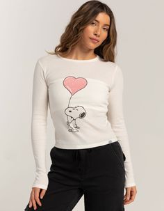 Rsq X Peanuts Love Collection Womens Snoopy Heart Long Sleeve Baby Tee. Large Graphic Screened On Front. Ribbed Crew Neckline. Long Sleeve. Fitted Silhouette. 50% Cotton, 50% Polyester. Machine Wash. Imported. Model Is Wearing A Size Medium. Model Measurements:height: 5'7" Bust: 34.5"waist: 27"hips: 38" | Rsq X Peanuts Love Collection Snoopy Heart Long Sleeve Baby Tee Cute Tops With Heart Graphic For Spring, Cute Fitted Top With Character Print, Playful Fitted Tops With Character Print, Fitted Playful Tops With Character Print, Cute Cotton Tops With Heart Print, Cute Cotton Tops With Heart Graphic, Playful Heart Graphic Tops For Spring, Cute Long Sleeve T-shirt With Heart Print, Playful White Heart Print Tops