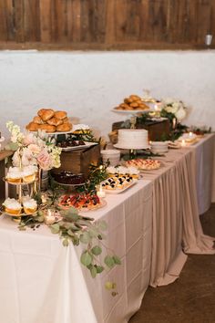 a table topped with lots of cakes and desserts