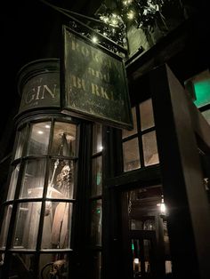 an old fashioned store front lit up at night