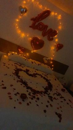 the bed is decorated with hearts and lights