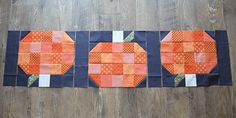 an orange and blue patchwork piece is laying on the floor