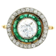 --Stone(s):-- (1) Natural Genuine Diamond - Old Eurepean Cut - Milgrain Bezel Set - F Color - VS2 Clarity - Approx. 1.25ct (28) Natural Genuine Diamonds - Old Single & Old Mine Cut - Pave Set (19) Natural Genuine Emeralds - Calibre Cut - Bezel Set - Vivid Green Color - Material: Solid 18k Yellow Gold w/ Platinum Top Weight: 3.43 Grams Ring Size: 9.0 (Fitted on a finger. We can custom size this ring - Please contact us prior to purchase for sizing inquiries) Ring Width: 14.7mm (0.58") (at its wid Edwardian Ring, Platinum Diamond Rings, Heart Shaped Diamond, Fancy Diamonds, Deco Engagement Ring, Platinum Ring, Three Stone Rings, Gold Diamond Rings, Emerald Diamond