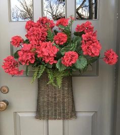 red flowers in a wicker basket on the front door