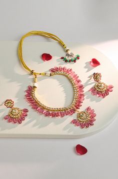 Elevate your traditional attire with this exquisite necklace set. The intricately crafted necklace features Kundan stones, beautifully complemented by stunning pink tourmaline stones, adding a touch of elegance and charm. Complete your look with the matching drop earrings for a timeless and sophisticated ensemble that's perfect for any occasion. Finish: 22KT Gold Plating Material: Silver, Copper Alloy, Kundan & Natural Stones Color: Pink Size: Free Size, Adjustable Closure Type: Draw String Box Hand Jewelry Rings, Chain Braid, Kundan Necklaces, Tourmaline Stone, Traditional Attire, Hand Jewelry, Anklet Jewelry, Charm Gift, Pink Tourmaline