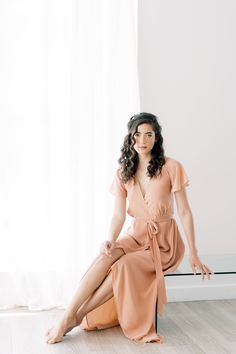 The Amalfi wrap dress is a classic style that any bridesmaid will love. When this skirt catches the breeze, our hearts are a flutter! We love wrap dresses because they fit and flatter all body types. Did we mention this dress has pockets? It has pockets! We promise you'll find many occasions to wear the Amalfi wrap dress.Custom Colour SelectionLet us know your preferred colour(s) in the note with your order. We will then confirm the colour swatch with you before starting to create your dress. Ma Flirty Tie Back Wedding Dress, Flowy Flirty Dress With Tie Waist, Flirty Flowy Dress With Tie Waist, Flirty Wrap Dress, Flirty Bridesmaid Dress With Tie Back, Flirty Bridesmaid Maxi Dress, Flowy Midi-length Wrap Dress With Tie Waist, Chic Fitted Wrap Dress For Wedding Guest, Chic Short Sleeve Midi Bridesmaid Dress