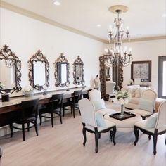 a living room filled with furniture and mirrors