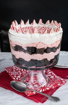 a cake in a glass dish on a red and white napkin