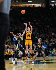 the basketball players are trying to block the ball