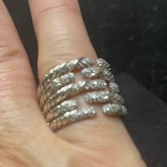 a woman's hand with a ring on it that has three rows of diamonds