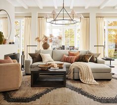 a living room filled with lots of furniture next to a fire place in front of a window