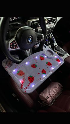 the interior of a car is decorated with red and white lights, including strawberrys