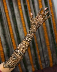 a woman's hand with henna tattoos on it