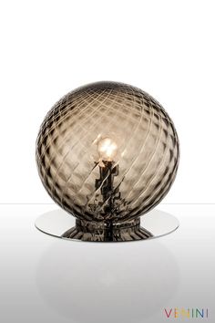 a glass ball with a light bulb on top