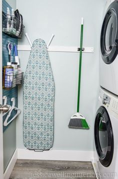 a washer and dryer in a small room with blue walls, flooring and accessories