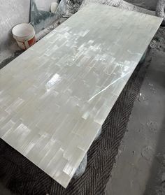 a large white marble slab sitting on top of a pile of cement next to a mirror