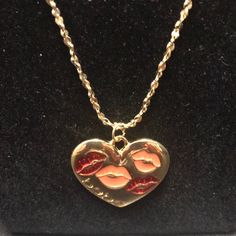 a gold necklace with two lips on it