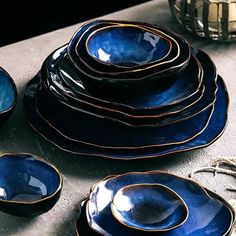 a table topped with lots of blue dishes