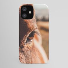 a horse's eye is seen through the lens of this phone case that features an image of a brown horse