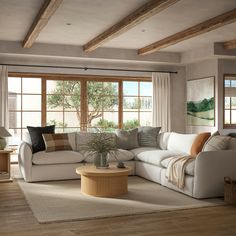 a living room filled with furniture and large windows