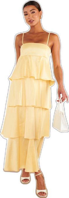 a woman in a yellow dress holding a white bag