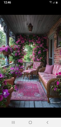 a porch covered in lots of pink flowers