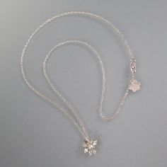 Feminine and dainty, this sculpted wildflower pendant necklace is perfect for every day wear. A simply elegant flower is hand-sculpted from recycled sterling silver and set with a 3.5-4mm round cultured freshwater pearl in a serrated bezel setting. The wildflower glides freely on your choice of an 18 or 20-inch slim sterling silver rope chain with a lobster claw clasp. Delicate White Gold Flower Pendant Necklace, Dainty White Gold Flower Pendant Necklace, Delicate Sterling Silver Flower Pendant Jewelry, Sterling Silver Flower Necklace In White Gold, Delicate Sterling Silver Flower Necklace For Wedding, 14kt Gold Jewelry, Necklace With Pearl, Silver Rope Chain, Flower Charm Necklace