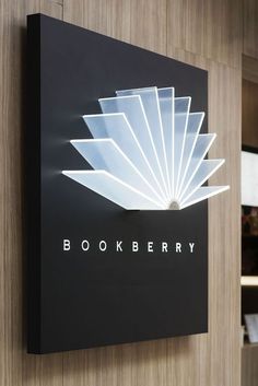 the bookberry logo is mounted on a wall in front of a bookshelf