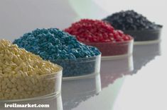 three bowls filled with different colored cereals on top of a white table next to each other