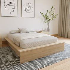 a bedroom with two paintings on the wall and a bed in the foreground,