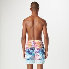 The Cosmo swim trunks are crafted from premium comfort stretch polyester in a tropical photoprint and feature an elastic waist with adjustable drawstring, a breathable stretch mesh lining, drainage grommets, side pockets, a rear patch flap pocket, UV protection and quick-dry technology. The sleek 17.5-inch out seam, offers the perfect balance between coverage and freedom of movement, making it an ideal choice for the beach or relaxing by the pool. Multicolor Swimwear With Built-in Shorts For Vacation, Tropical Multicolor Shorts For Pool, Tropical Multicolor Swim Trunks With Built-in Shorts, Tropical Multicolor Short Swim Trunks, Tropical Multicolor Short Length Swimwear, Tropical Multicolor Swim Trunks For Vacation, Multicolor Swim Trunks For Poolside Vacation, Printed Swim Trunks For Poolside Vacation, Multicolor Swimwear With Built-in Shorts For Pool