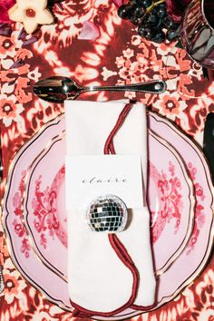 a plate with a disco ball on it next to a napkin and utensils