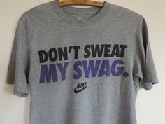 Vintage Tee Shirt. Nike Athletic Wear 100% Cotton T. Shirt featuring Nike Don't Sweat My Swag! Gray T Shirt featuring Black and Purple Lettering Nike Logo... DON'T SWEAT MY SWAG! Size S One T shirt Please visit my Shop for Trendy Vintage Goods!  https://www.etsy.com/shop/SevenSeven52Vintage Thank you so much!! Sporty Athletic Heather T-shirt With Text Print, Sportswear Crew Neck T-shirt With Letter Print, Workout Crew Neck Tops With Screen Print, Sporty T-shirt With Comfortable Fit And Crew Neck, Sporty Crew Neck T-shirt With Comfortable Fit, Sports Slogan T-shirt Crew Neck, Crew Neck Slogan T-shirt For Sports, Crew Neck Sports T-shirt With Slogan, Sports Tops With Screen Print In Relaxed Fit