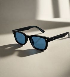 Expertly designed with a classic wayfarer style, the Icon sunglasses offer 100% UV protection with its black acetate frame and blue lenses. The square frame gives a sleek and modern look, making them perfect for any occasion. Add a touch of sophistication to your wardrobe with the Icon style sunglasses. Unisex. Retro Blue Wayfarer Sunglasses, Classic Blue Sunglasses With Uv Protection, Icon Style, Blue Lens, Style Sunglasses, Blue Lenses, The Square, Square Frame, Square Frames