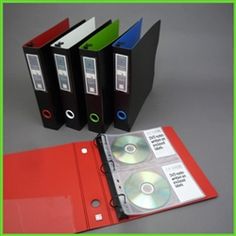 three binders with cd's in them sitting next to each other