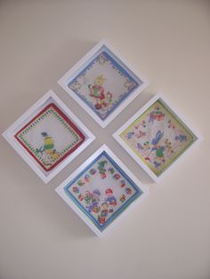 four framed pictures on the wall with different designs and colors, each featuring an image of winnie the pooh