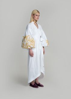 Luxurious White/Gold Kolossya Women's Midi Caftan Yuliya Magdych Elegant Spring Kaftan With Embroidered Sleeves, Traditional Cotton Dress With Embroidered Sleeves, Cotton Kaftan With Geometric Embroidery, White Cotton Dress With Embroidered Sleeves, White Cotton Kaftan With Chikankari Embroidery, White Long-sleeve Kaftan With Woven Motifs, Elegant Summer Cotton Kaftan, White Long Sleeve Kaftan With Woven Motifs, Spring Cotton Kaftan With Geometric Embroidery