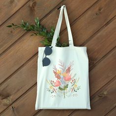 "Check out our Watercolor Flower Bouquet Canvas Tote Bag! This stylish and practical tote bag features a beautiful wildflower watercolor design that is perfect for spring. Ideal for carrying your essentials, this bag is made from high-quality canvas material that is both durable and easy to clean. It's great for everyday use or as a gift for a friend or loved one. Get yours today and add a touch of beauty to your everyday style. Whether you're running errands or heading to the beach, this tote bag has got you covered.  Measuring at 15.75\"h x 15.25\"w and with a handle length of 21.5\", these tote bags are with 100% cotton sheeting. Add their reinforced handle stitching to the mix, and you got a reliable bag rich in both practicality and durability. ❀ Material: 100% cotton sheeting ❀ One s Watercolor Flower Bouquet, Wildflower Watercolor, Aesthetic Canvas, Spring Watercolor, Floral Aesthetic, Flower Water, Wildflower Bouquet, Watercolor Flower, Water Flowers