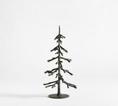 a small tree made out of branches on a white background with no people around it