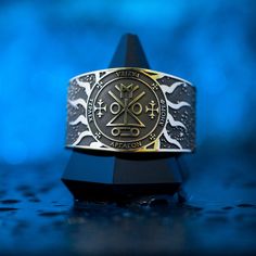 a gold and silver ring with the seal of solomon on it's center piece