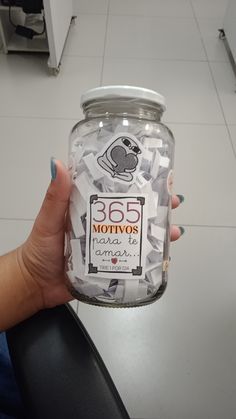 a person holding a jar full of stickers in their hand with the label 350 motives on it