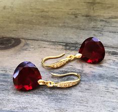 "Burgundy Garnet gold pave earrings. Heart cut garnets. Red stone jewelry. Red garnet dangles. Dark red garnet drops. Junuary birthstone. Available in 3 finishes. Length 1 1/4\". Dark red faceted gems are 14x14 mm as photo are sold, 19x14 mm and 13x17 mm stones are available. These beautiful earrings will arrive in a jewelry box ready for gift giving." Red Heart Cut Elegant Earrings, Elegant Red Heart Cut Earrings, Red Faceted Garnet Earrings, Elegant Red Birthstone Earrings, Elegant Burgundy Jewelry For Valentine's Day, Red Faceted Earrings For Anniversary, Red Stone Jewelry, Pave Earrings, Garnet And Gold